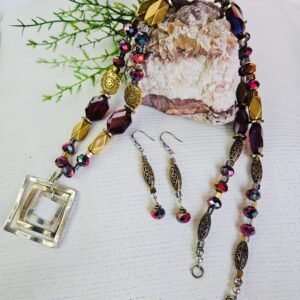 26" Faceted red glass with gold tone and stainless steel accents and pendant.