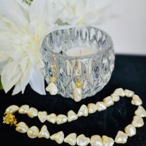 18" cultured fresh water ivory pearls with gold tone clasp and 2" earrings with rhinestone.