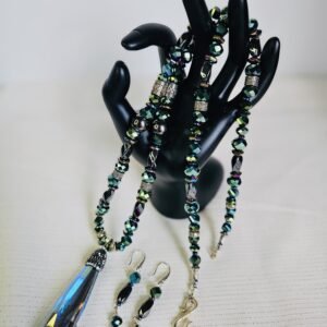 20250621 09173726" necklace with 3" crystal pendant and 2 1/2" earrings. Metallic teal green beads with a hint of purple and stainless steel accents.