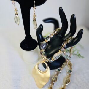 24" Necklace and 2" earrings in faceted glass with a gold tone pendant.