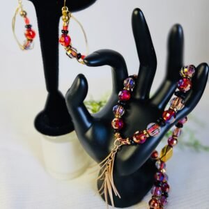 20" necklace and wire earrings in red, gold and black with a gold tone pendant.